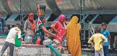  ?? AFP ?? Women filling their pitchers with water supplied by a special train on a hot day in Pali, in the desert state of Rajasthan.