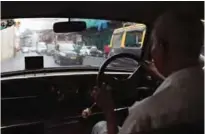  ??  ?? Indian taxi driver Dawood Khan, 80, drives his Premiere Padmini taxi along a street in Mumbai.