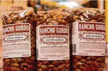  ?? Jessica Christian/The Chronicle 2021 ?? Rancho Gordo Ayocote Amarillo beans sit on display in a retail space in Napa. The company was started there 20 years ago.