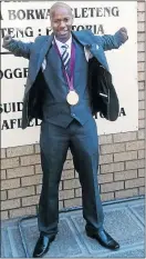  ??  ?? Paralympic champ Samkelo Radebe posing in front of the North Gauteng High Court with his gold medal.