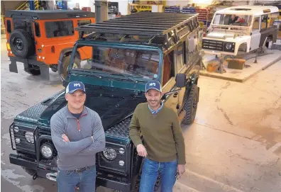  ?? GREG SORBER/JOURNAL ?? Chris Taylor, left, and Doug Turner are partners in Land Rover Heritage Driven, a business that restores and modifies classic Land Rovers. They are standing next to a client’s rebuilt and modernized Land Rover Defender on Jan. 31.