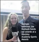  ??  ?? Olympic swimmer Joe Roebuck hands out awards at a Hinckley Academy Sports Awards