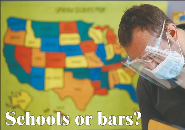  ?? (AP/Charlie Neibergall) ?? Custodian Joel Cruz cleans a desk Wednesday in a classroom at Brubaker Elementary School in Des Moines, Iowa.