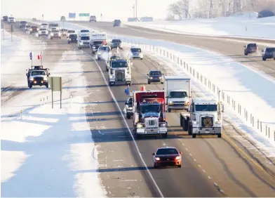  ?? JEFF MCINTOSH / THE CANADIAN PRESS ?? The “United We Roll” convoy of tractor-trailers, at top, rolls down the highway near Red Deer, Alta., on Thursday, en route to Ottawa to draw attention to the lack of support for the energy sector and pipelines. Brad Schell, right, seen south of Calgary earlier in the week, says he will be joining the convoy on its journey to Ontario.