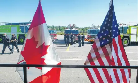  ?? RYAN TAPLIN • THE CHRONICLE HERALD ?? Fire trucks are lined up outside a hangar at Halifax Stanfield Internatio­nal Airport for a ceremony Saturday marking the 20th anniversar­y of the Sept. 11 terrorist attacks in the United States.