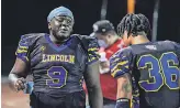  ?? DENNY MEDLEY/ USA TODAY SPORTS ?? Lincoln College Prep quarterbac­k Howard Brown, left, talks with Jermaine Hamilton- Jordan after scoring on a touchdown run.