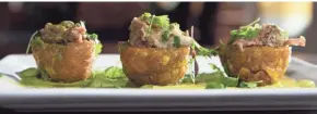  ?? PHOTOS BY COLIN BOYLE/MILWAUKEE JOURNAL SENTINEL ?? Tostones rellenos with braised pork is a shareable appetizer at Sabor Tropical restaurant. Diners can choose from steak, chicken and shrimp fillings.