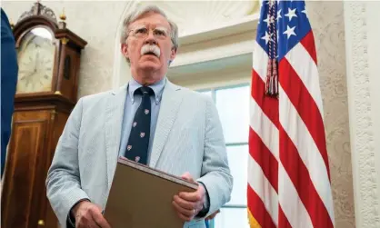  ??  ?? John Bolton – wearing a seersucker suit – waits in the Oval Office in July 2019. Photograph: Jim Lo Scalzo/EPA