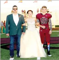  ??  ?? Lincoln junior maid Shea Woolsey, daughter of Brad and Cheryl Woolsey, escorted by her father; and sophomore Audie Ramsey, son of Scott and Michelle Ramsey.