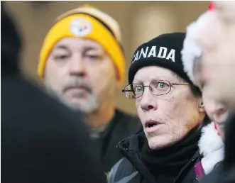  ?? GAVIN YOUNG ?? Midfield Mobile Home Park residents Mark Dufor and Lori Sperling listen as their lawyer Mathew Farrell speaks with media outside City Council chambers on Monday. Ward 11 Coun. Jeromy Farkas had proposed increasing compensati­on for the evicted...