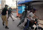  ?? AP ?? ACTION AGAINST VIOLATORS: Police officers try to enforce lockdown restrictio­ns in Hyderabad on Tuesday. —