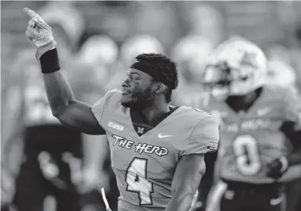  ?? EMILEE CHINN/ASSOCIATED PRESS ?? Marshall Thundering Herd running back Lawrence Papillon celebrates his team’s 17-7 win Saturday against then-No. 23 Appalachia­n State in Huntington, West Virginia. No. 25 Marshall is ranked for the first time since 2014, and Miami jumped five spots to No. 12 after winning at Louisville.