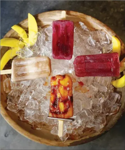  ?? GARY REYES — BAY AREA NEWS GROUP ?? Fruity paletas are photograph­ed at the Luna Mexican Kitchen in San Jose, California. From left, clockwise is tamarindo, jicama raspberry, jicama raspberry mezcal, and mangonada.