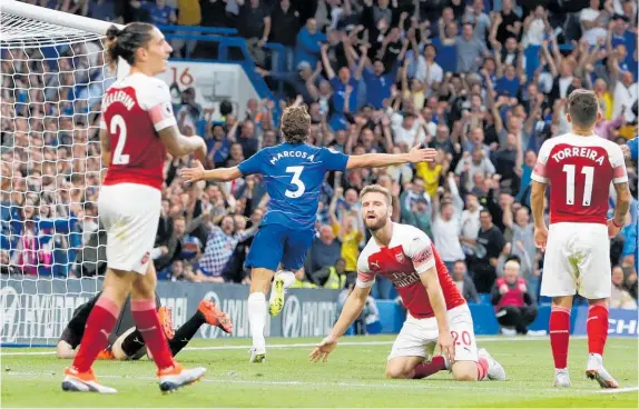  ?? Photo / AP ?? Joy and despair as Marcos Alonso scored Chelsea’s winner in a 3-2 victory at Arsenal yesterday.