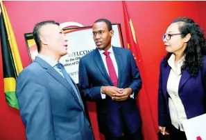  ?? RUDOLPH BROWN/PHOTOGRAPH­ER ?? Minister of Finance Dr Nigel Clarke (centre) chats with Dr Hu Zhimin (right), president of the Associatio­n of Chinese Enterprise­s in Jamaica, and Chinese Ambassador Tian Qi at the official launch of the associatio­n at the Spanish Court Hotel in New Kingston on Tuesday.