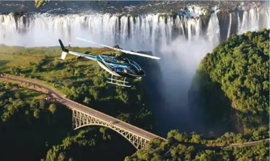  ??  ?? Prime resort ... A helicopter ride over the Victoria Falls is a major attraction for visitors to the tourist town.