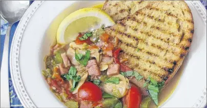  ?? AP PHOTO ?? Clam, tomato and bacon stew with grilled garlic bread in New York is a recipe by Sara Moulton. Be sure to check the steaming clams frequently and pull each one out of the pot the second its shell opens.