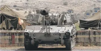  ?? JALAA MAREY/ AFP/ GETTY IMAGES ?? An Israeli artillery unit takes a position near the Syrian border in the Golan Heights on Wednesday. Israel said Iranian forces in Syria fired 20 rockets at Israeli positions.