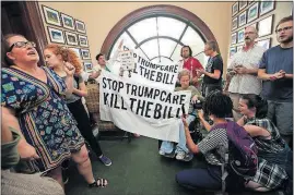  ?? [MANUEL BALCE CENETA/THE ASSOCIATED PRESS] ?? Protesters against the Republican health care bill rally inside the office of Ohio Republican Sen. Rob Portman on Capitol Hill on Monday. It’s now looking as if Portman’s vote on the bill may not be crucial.