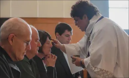  ?? ERIC BONZAR — THE MORNING JOURNAL ?? The Rev. Rosalina Rivera applies ashes to the forehead of parishione­rs Feb. 14, during First Lutheran Church’s afternoon Ash Wednesday service.