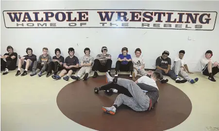  ?? STaff pHoToS By JoHN WILCoX ?? WATCH AND LEARN: Walpole wrestlers watch a demonstrat­ion during their practice Wednesday. At right, Rebels wrestlers, from left, Luke Wassel, Aidan Fitzgerald, Sean McCullough and Patrick Lanahan work through their moves.