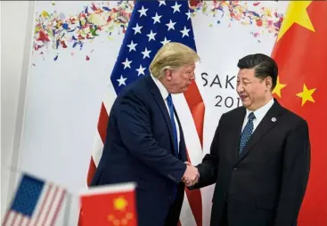  ?? — AFP ?? after meeting Xi (right), Trump announced that Huawei can now purchase equipment from us companies.
