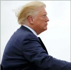  ?? CAROLYN KASTER — THE ASSOCIATED PRESS ?? President Donald Trump boards Air Force One, Wednesday in Andrews Air Force Base, Md., en route to a campaign rally in Greenville, N.C.