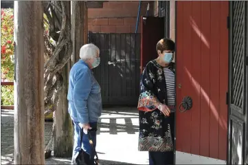  ?? PHOTOS BY JUSTIN COUCHOT — ENTERPRISE-RECORD ?? Chinese Temple Docent Ann Chamberlai­n, right, opens the doors to the tapestry room for visitor Barbara Adkerson on Saturday at the Chinese Temple Museum in Oroville. The Chinese Temple Museum was the second museum to open in Oroville after Butte County moved into the red, less restrictiv­e COVID-19tier. Bolts Antique Toy Museum in Oroville opened on April 3.