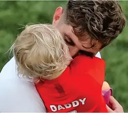  ??  ?? Hug from Daddy: England’s John Stones with his daughter