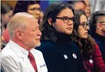  ?? JOHN HANNA/AP ?? Adam Kellogg (center), a University of Kansas student and transgende­r man, follows a Kansas Senate hearing on legislatio­n aimed at preventing gender-affirming care for minors.