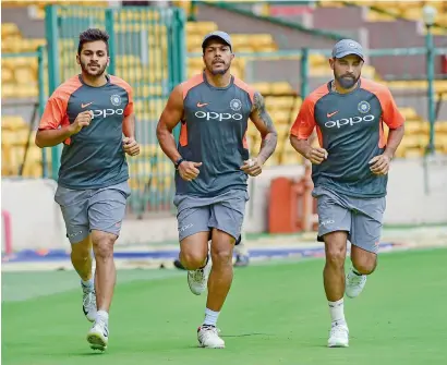  ?? PTI ?? Indian medium pacers Shami (right), Umesh Yadav and Shardul Thakur (left) attend a practice session ahead of their maiden Test against Afghanista­n. Shami later was ruled out as he failed to clear the fitness test. —