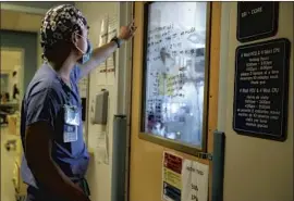  ?? Dania Maxwell Los Angeles Times ?? THOUSANDS of healthcare workers have contracted the coronaviru­s in recent weeks. Above, a nurse in a makeshift ICU wing at Harbor- UCLA Medical Center.