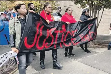  ?? Kim Chandler Associated Press ?? PROTESTERS demonstrat­e at the Riverchase Galleria in Hoover, Ala. They had a moment of silence for E.J. Bradford at the spot where he was killed. A gunman, still at large, wounded an 18-year-old and a 12-year-old.