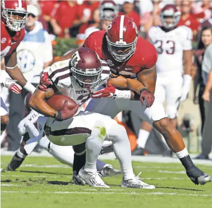  ?? MARVIN GENTRY, USA TODAY SPORTS ?? Linebacker Ryan Anderson, right, tackles Texas A&M wide receiver Christian Kirk during Alabama’s 33-14 win Saturday that improved the top-ranked Crimson Tide to 8-0.