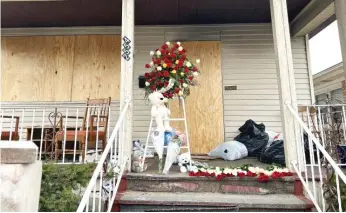  ?? EMMANUEL CAMARILLO/SUN-TIMES ?? A memorial grows Thursday for Ezra Stewart, a 7-year-old boy who died after a fire broke out at his family’s home in the 2500 block of North Rutherford Avenue in the Montclare neighborho­od.