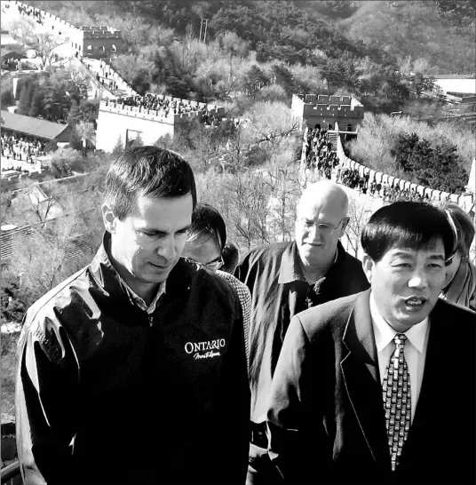  ?? RICHARD BRENNAN/TORONTO STAR ?? Premier Dalton McGuinty, who’s leading a trade mission to China, walks with Guo Zaoshun, chief of the Badaling Trade Union, along the Great Wall yesterday.