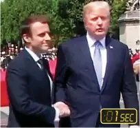  ??  ?? Good start: Macron and Trump shake hands