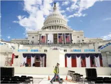  ?? Mark Wilson / Getty Images ?? A crew member walks across the stage going up for Presidente­lect Donald Trump’s inaugurati­on Friday in Washington.