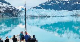  ??  ?? Passengers await the thunderous sound of icebergs calving from the Margerie Glacier.