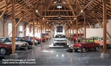  ??  ?? Mazda’s first passenger car, the R360 (right), beside the new MX-30 (centre)