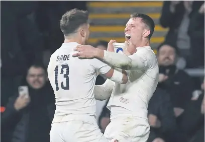  ?? Picture: AFP ?? YOU BEAUTY! England’s centre Fraser Dingwall (right) celebrates with team-mate Henry Slade after scoring a try during their Six Nations match against Wales at Twickenham on Saturday.