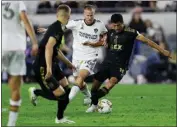  ?? PHOTO BY TREVOR STAMP ?? LAFC's Carlos Vela, right, battles for the ball with the Galaxy's Uri Rosell (16) in an MLS match earlier this month.