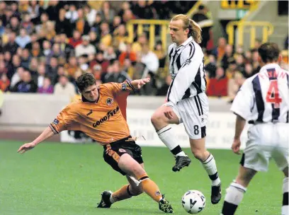  ??  ?? Carl Robinson tackles Richard Sneekes