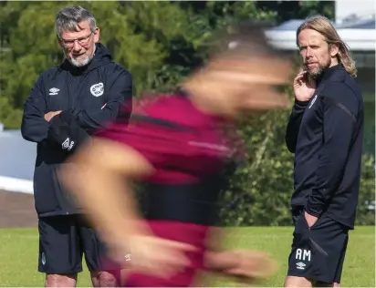  ??  ?? It’s all a blur: Levein and assistant boss Austin MacPhee observe Hearts training yesterday