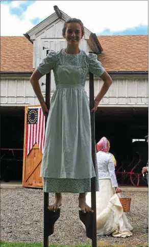  ?? TRACEY READ — THE NEWS-HERALD ?? Megan Maddox, a 17-year-old Huntsburg Township resident, walks on stilts May 27 at the semi-annual Civil War Encampment held at Century Village in Burton Township.