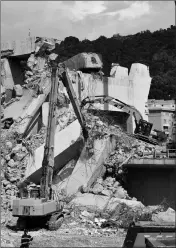  ?? ASSOCIATED PRESS ?? CATERPILLA­RS REMOVE DEBRIS from the collapsed Morandi highway bridge, in Genoa, Italy, Friday.