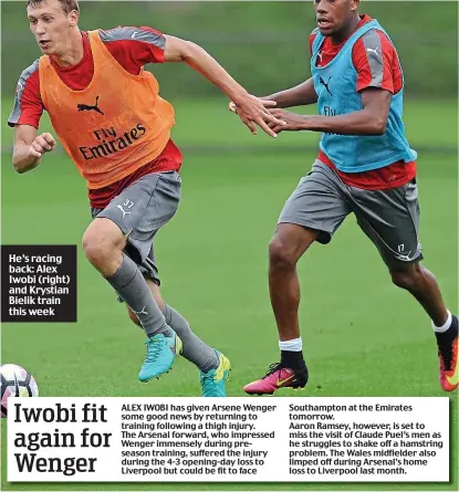  ??  ?? He’s racing back: Alex Iwobi (right) and Krystian Bielik train this week