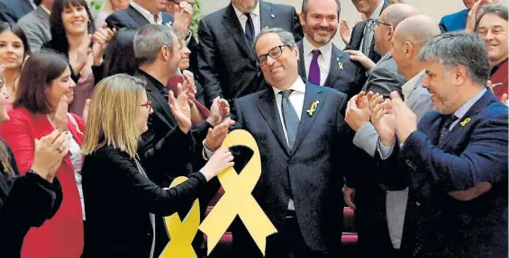  ?? AFP ?? Felicitado. El nuevo presidente de Cataluña, Quim Torra, recibe el saludo de los miembros de la bancada independen­tista en el Parlamento.