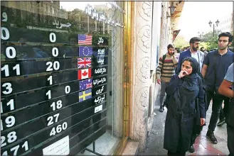  ?? (AP) ?? An exchange shop displays rates for various currencies, in downtown Tehran, Iran, on Oct 2. Iran’s currency, the rial, unexpected­ly rallied Tuesday after weeks of depreciati­on following President Donald Trump’s decision to withdraw America from Tehran’s nuclear deal with world powers, sending Iranians rushing to exchange shops tocash in.