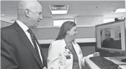 ?? CHRISTIANA CARE HEALTH SYSTEM ?? Pharmicist Kelly Ann Steeves instructs patient Anthony Tramonte while former Delaware Gov. Jack Markell looks on.